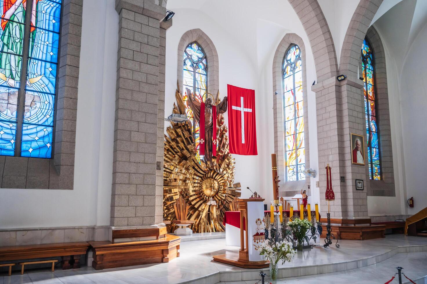 Altar with Jesus Christ and a cross in interior of Christian Catholic church. Cathedral of Sacred Heart of Jesus. Tashkent, Uzbekistan - April 18, 2024 photo