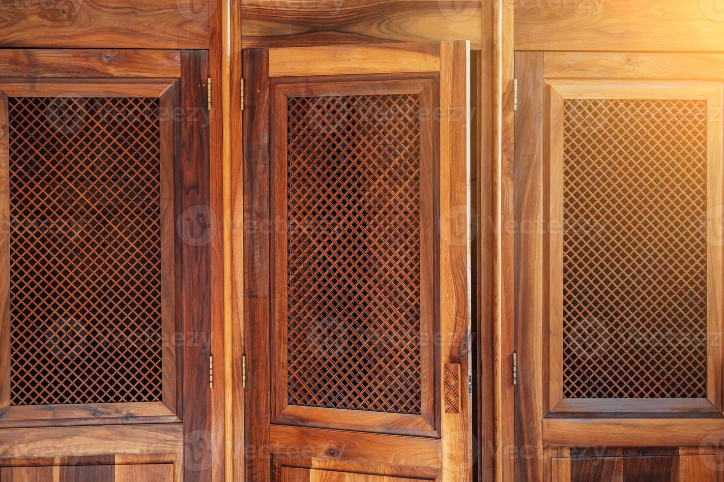 open wooden door with lattice to confessional for confession inside the Catholic Cathedral close-up photo