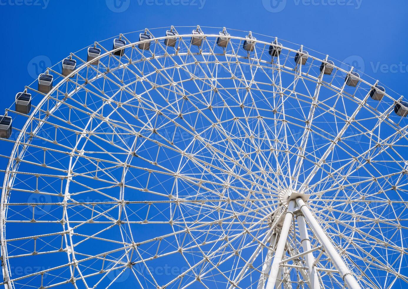 white big Ferris wheel on background a clear blue sky in amusement park with copy space photo