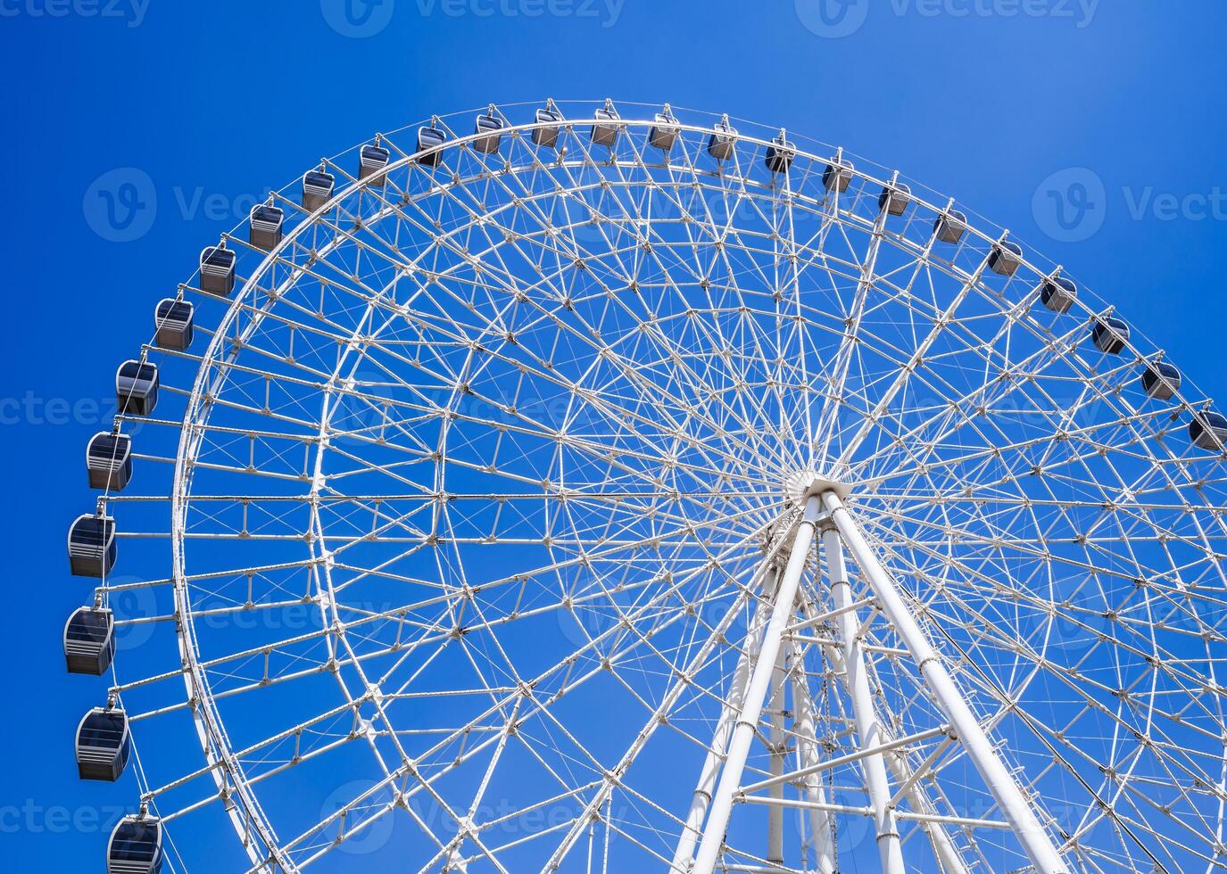 white big ferris wheel on background a clear blue sky in Navruz Park in Tashkent in summer photo