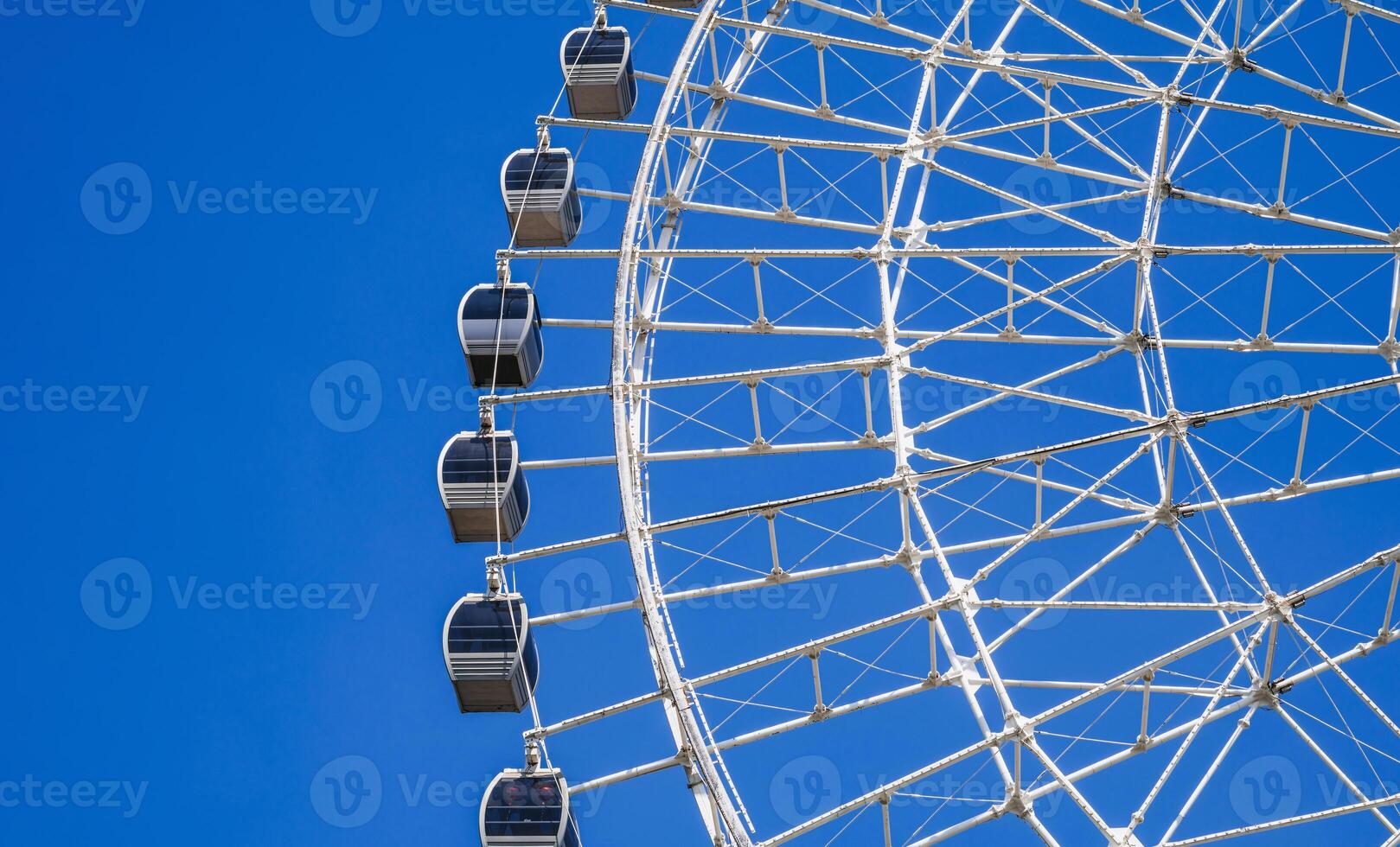 white big ferris wheel on background clear blue sky in Navruz Park in Tashkent close-up photo