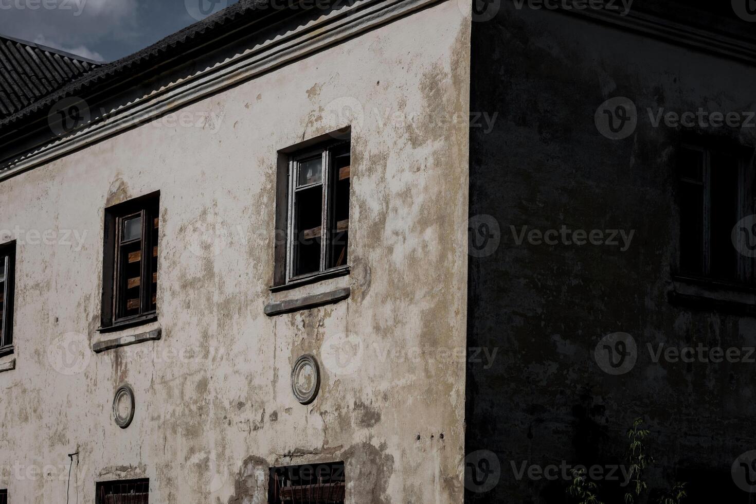 abandoned building with broken windows photo