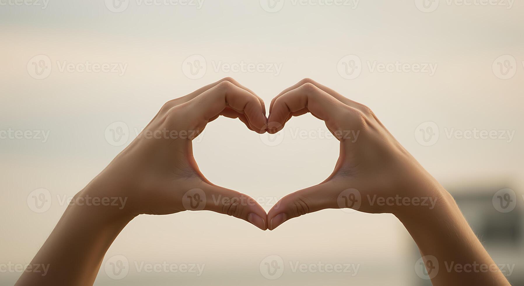 Heart-Shaped Hands Against a Soft Sky photo