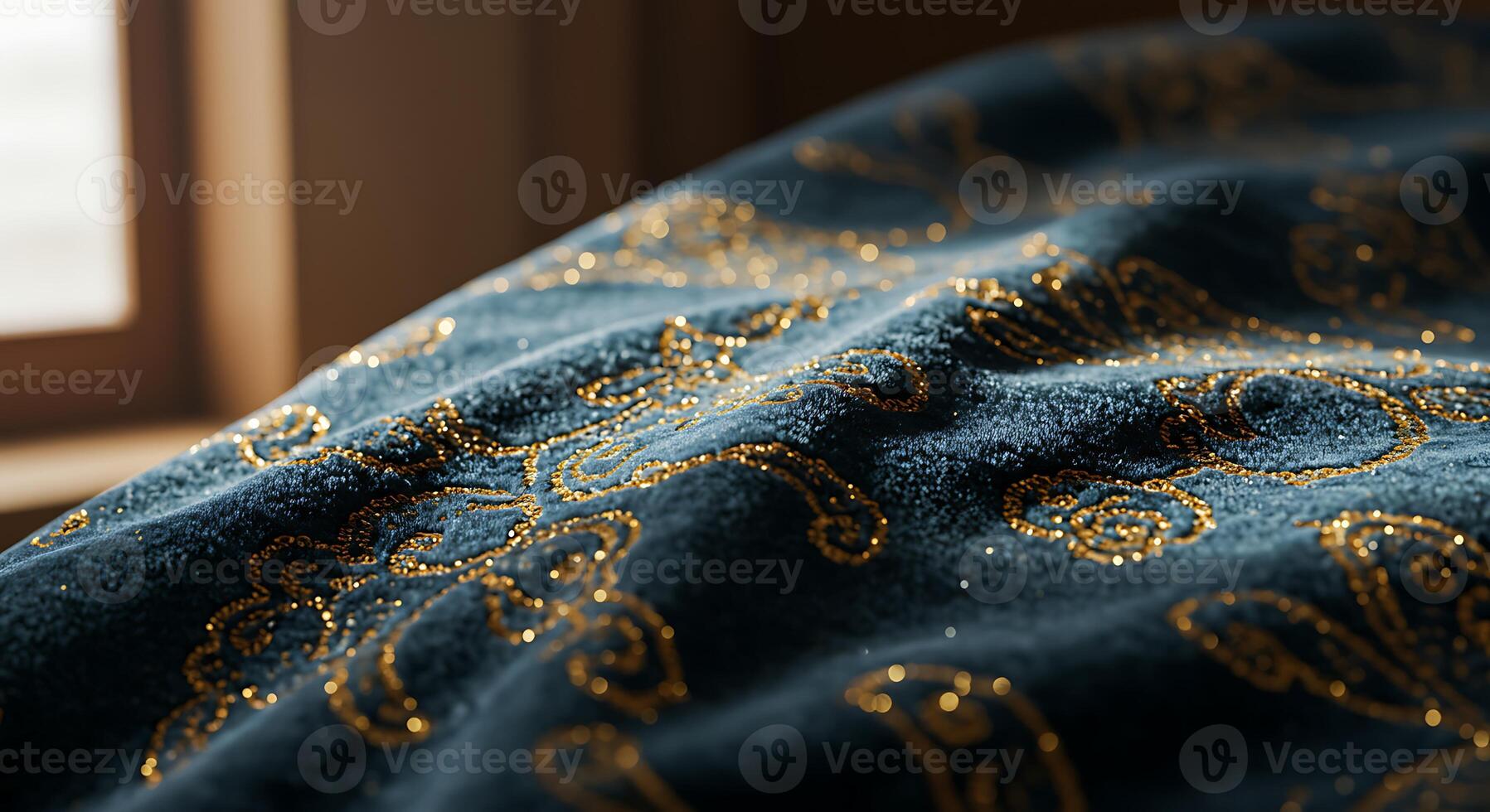 A close up of a blue and gold patterned blanket photo