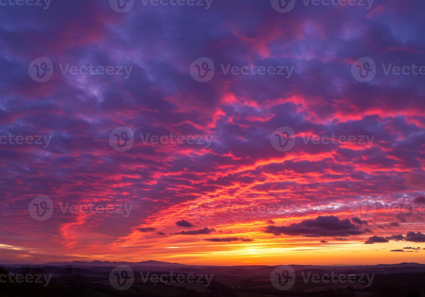 A colorful sunset over a valley with clouds photo