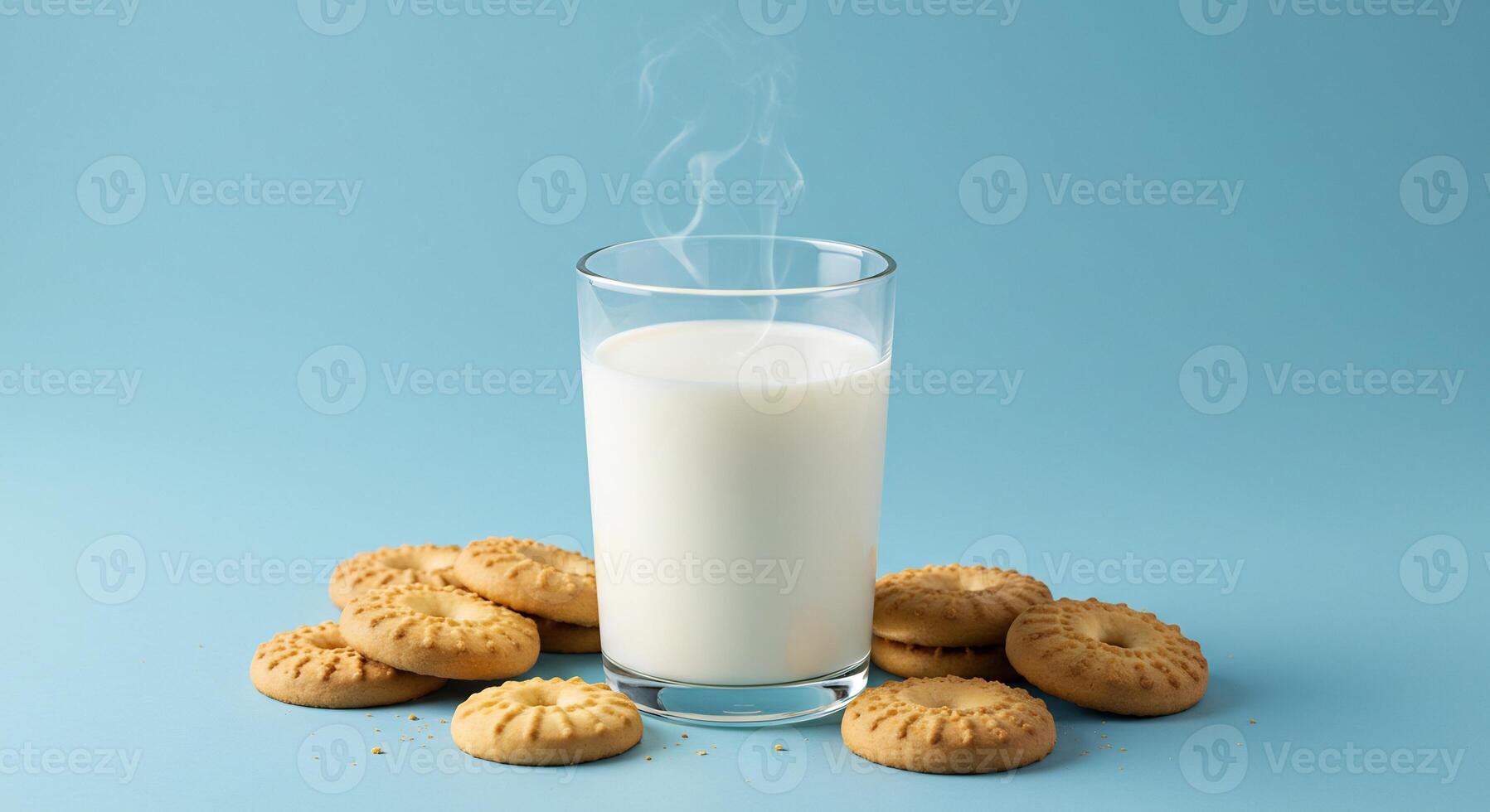A glass of milk and cookies on a blue background photo