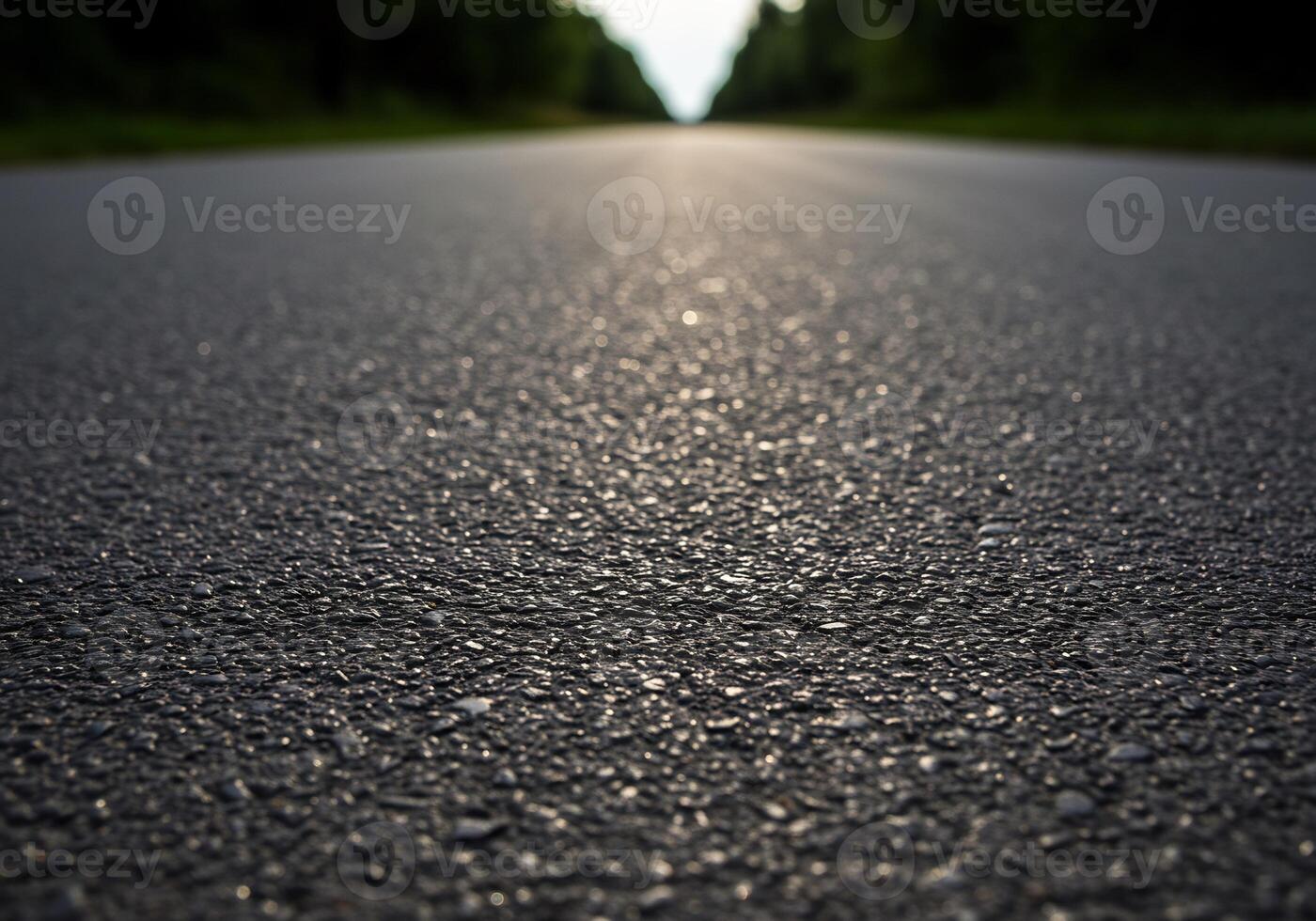 An empty road with a sun shining down on it photo