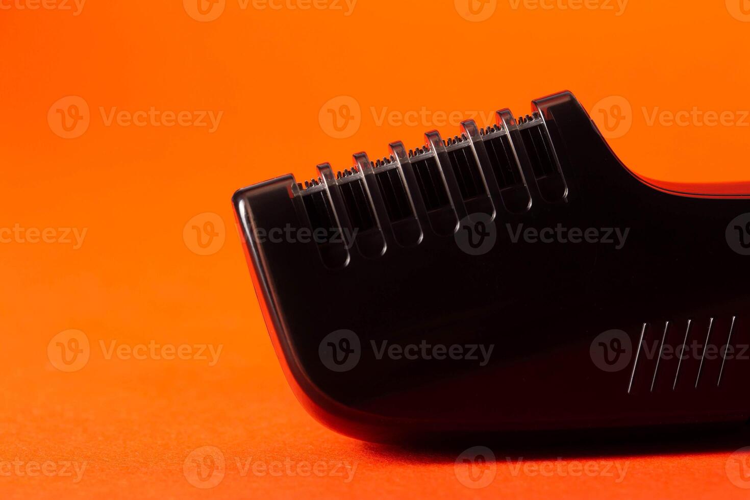 body attachment on a trimmer on a red background, close-up. Copy space for text photo