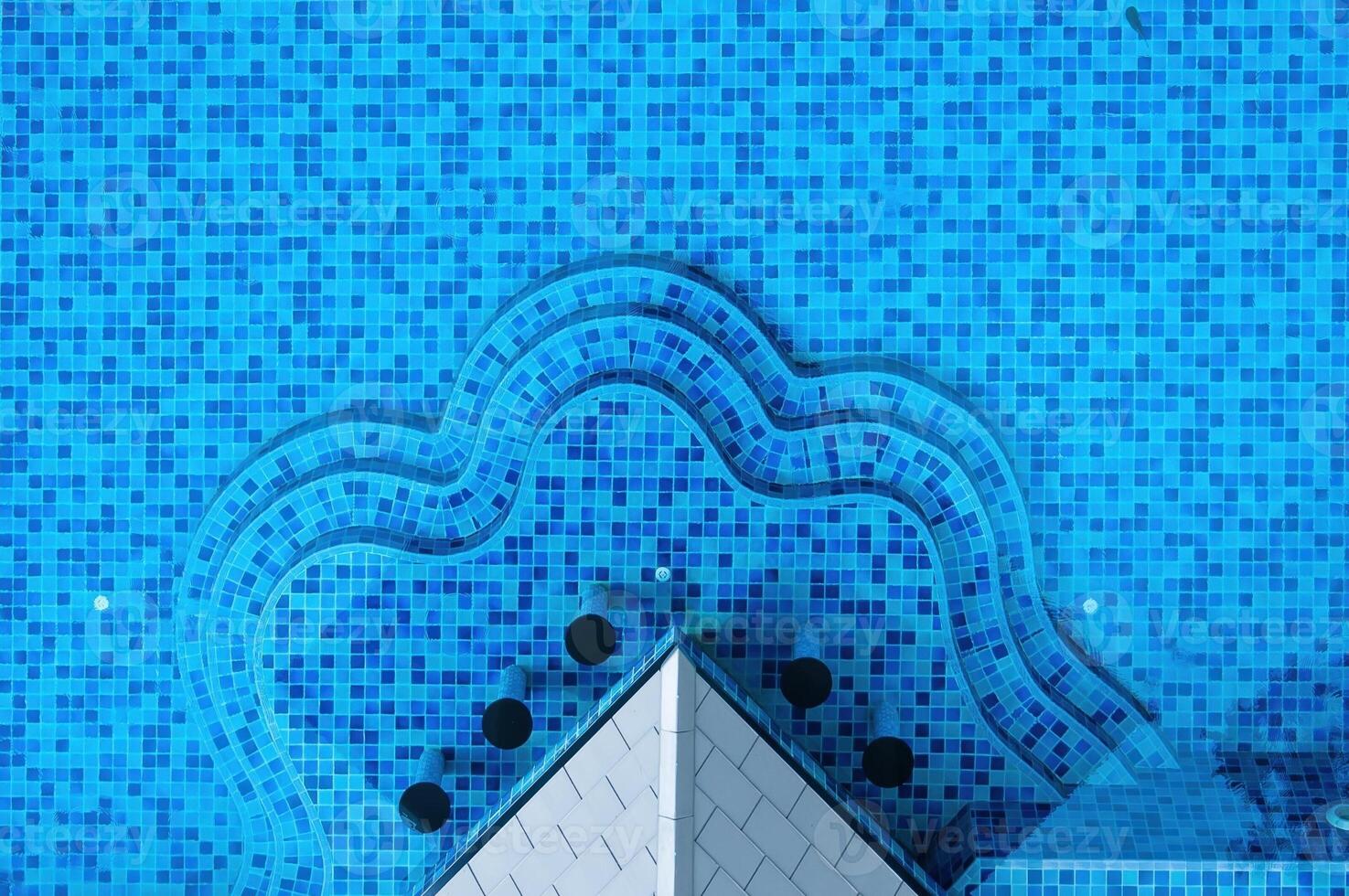 Stunning aerial view of a sparkling pool with unique shape and vibrant tiles photo