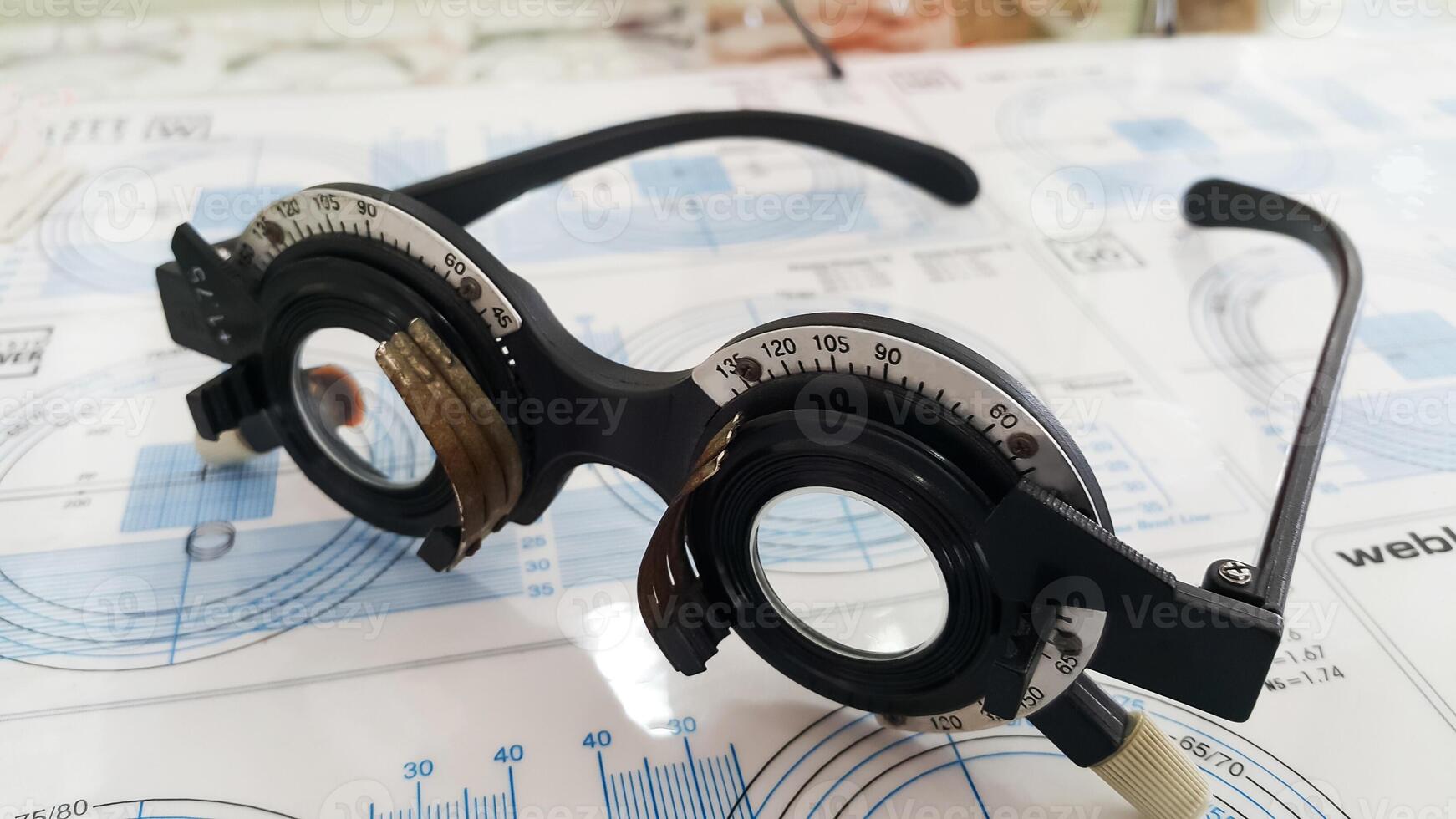 Phoropter eyeglasses on display in an optometry office during an eye exam session photo