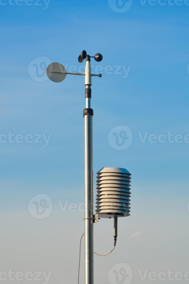 Weather monitoring station capturing atmospheric conditions in clear skies photo