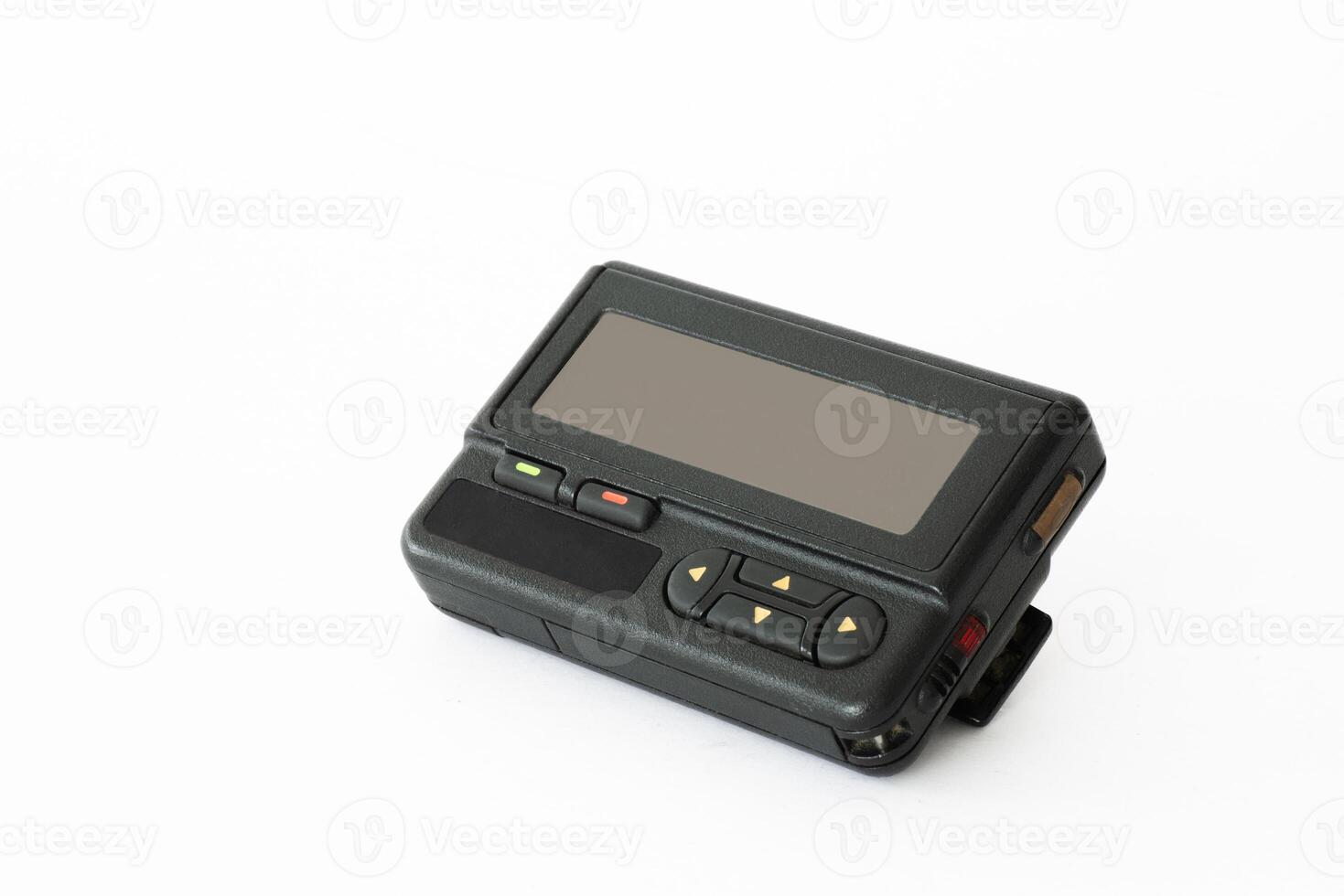 Vintage pager lying on a white surface showcasing retro technology and communication history photo