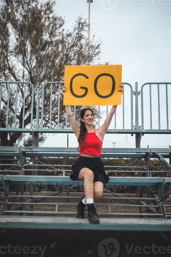 Cheerleader Girl Cheers Her Heart Basketball Team On The Stands photo