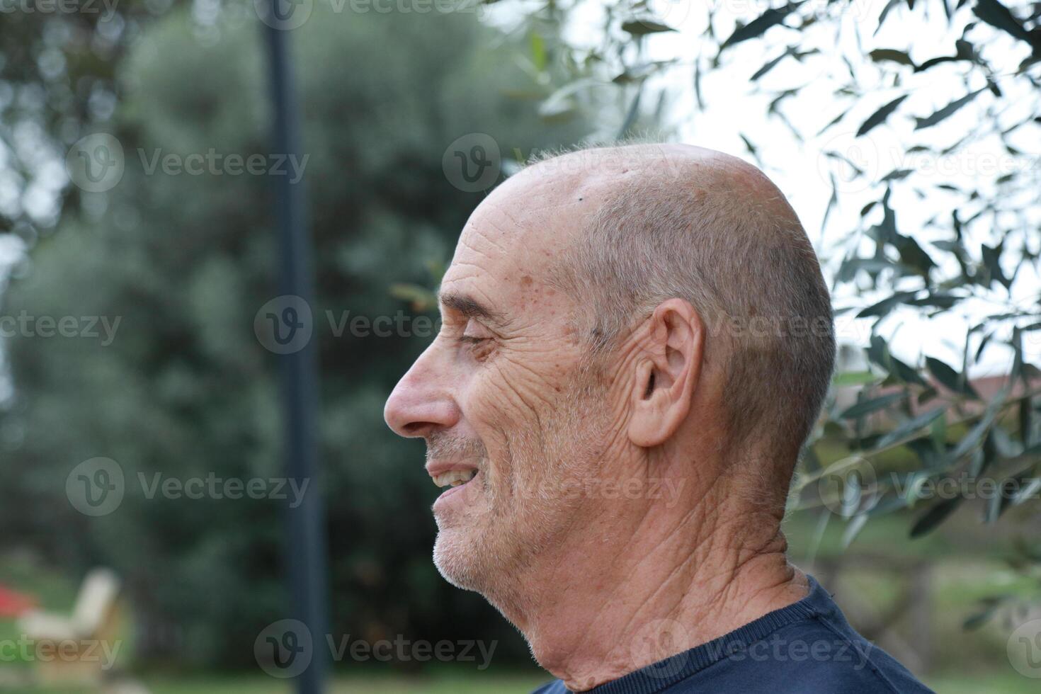 Elderly Man Makes Call In His Countryside Outdoors And Talks On The Phone photo