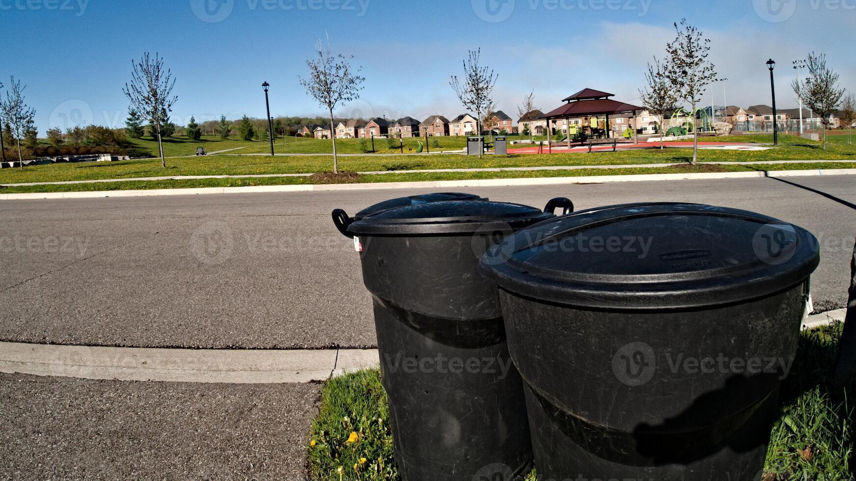 Two Trash Cans by Roadside in Toronto photo