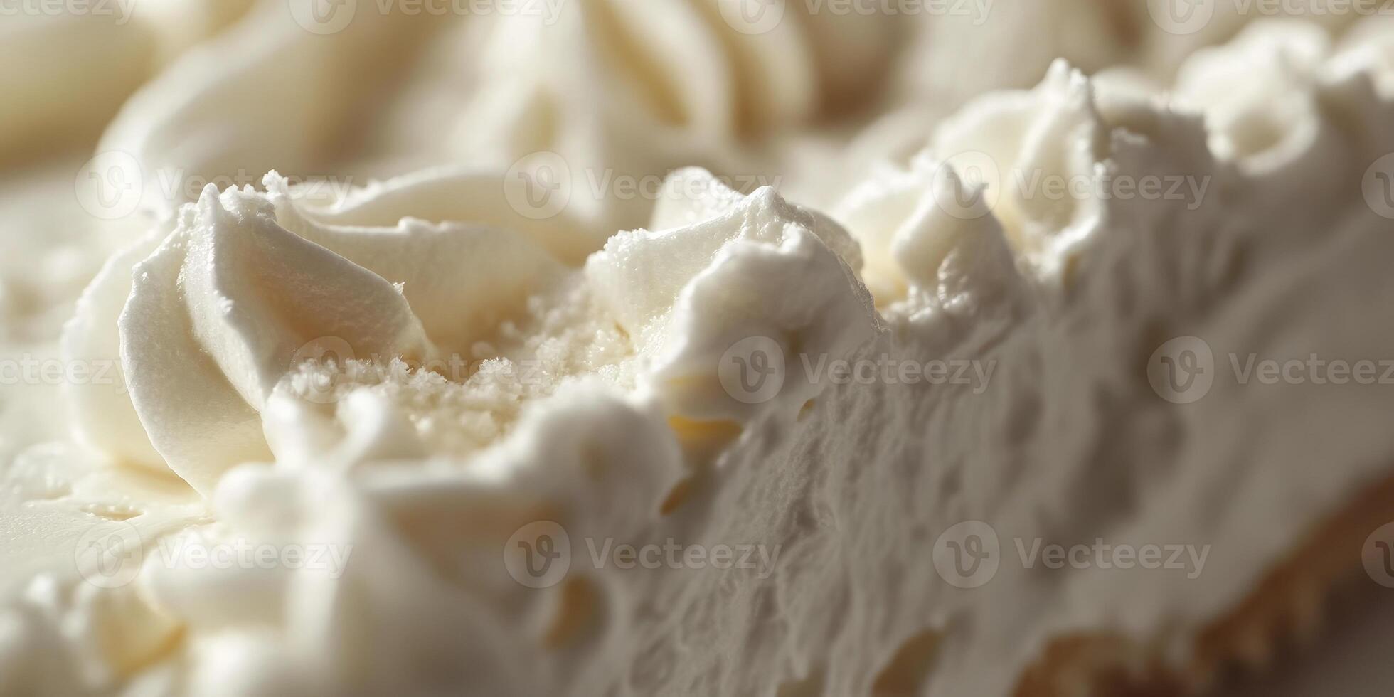A close up of a piece of white cake with frosting photo