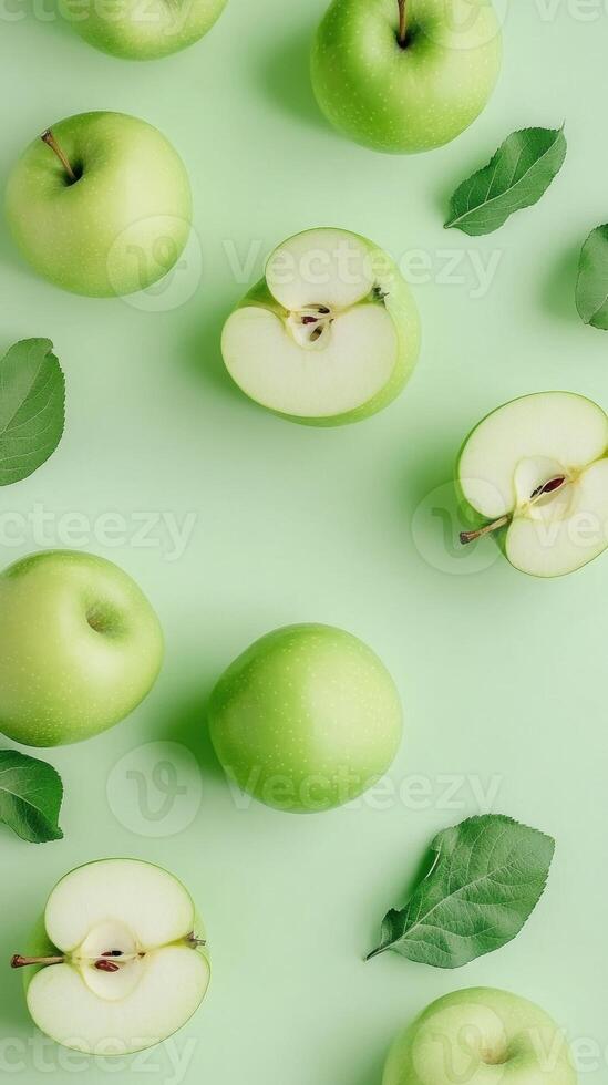 Fresh green apples and leaves on a soft green background creating a refreshing and natural vibe. photo