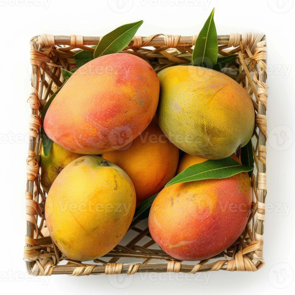 Ripe mangos in a woven basket with vibrant colors and fresh leaves. photo