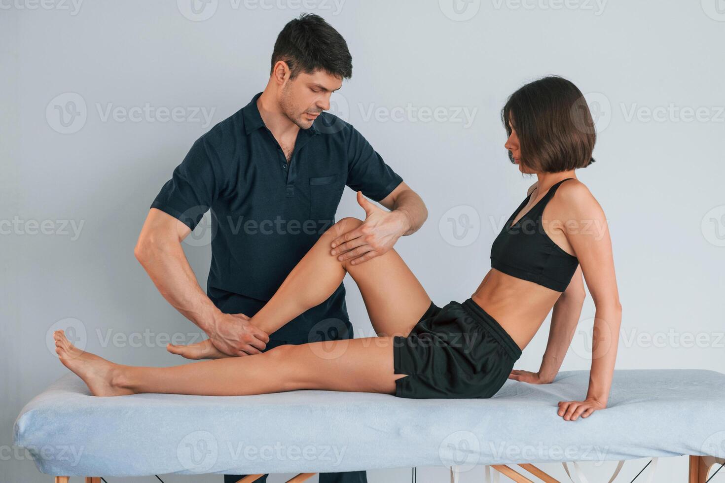 Laying down on the table. Woman visiting physiologist that making massages and helping with traumas photo