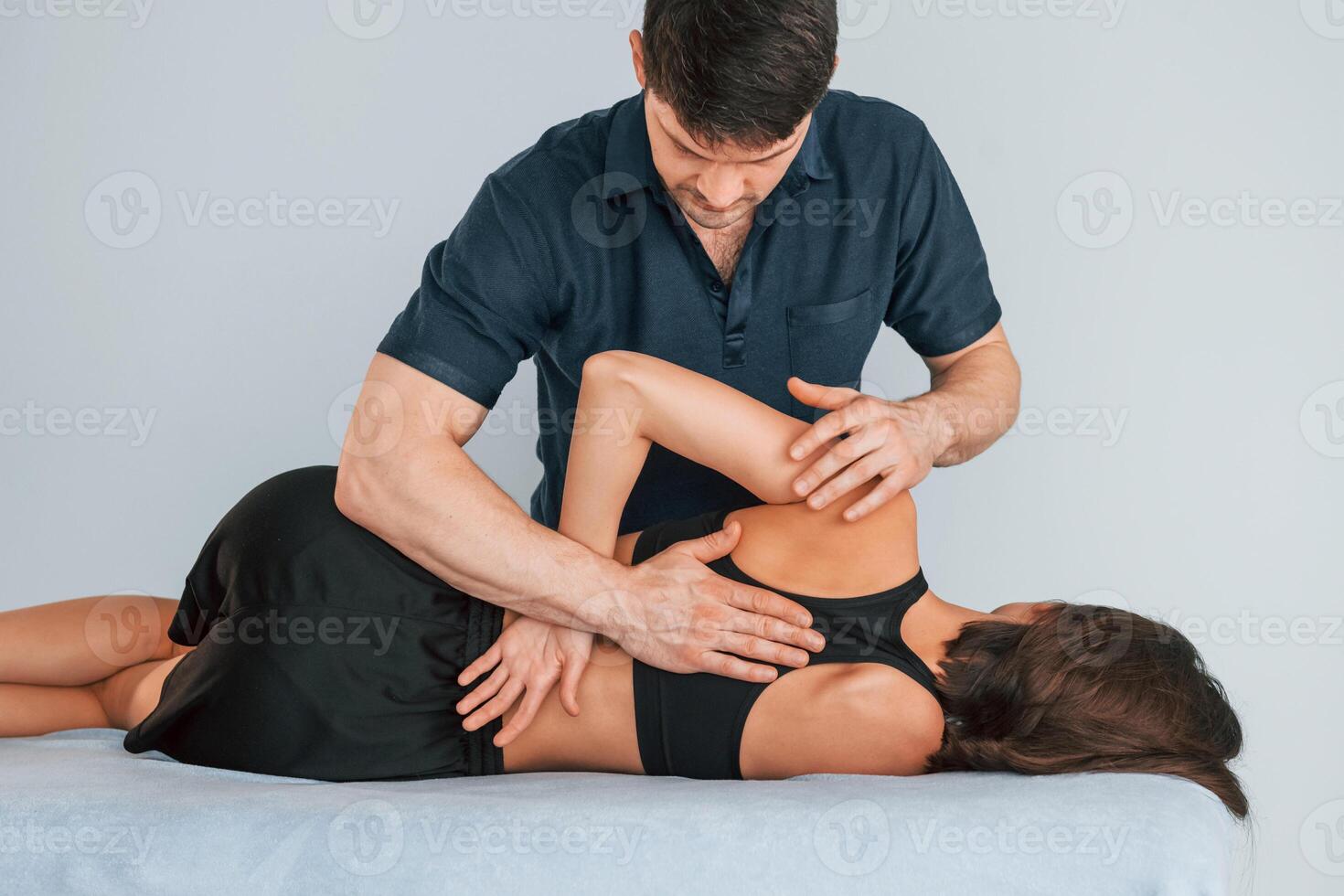 Working with spine and neck.. Woman visiting physiologist that making massages and helping with traumas photo