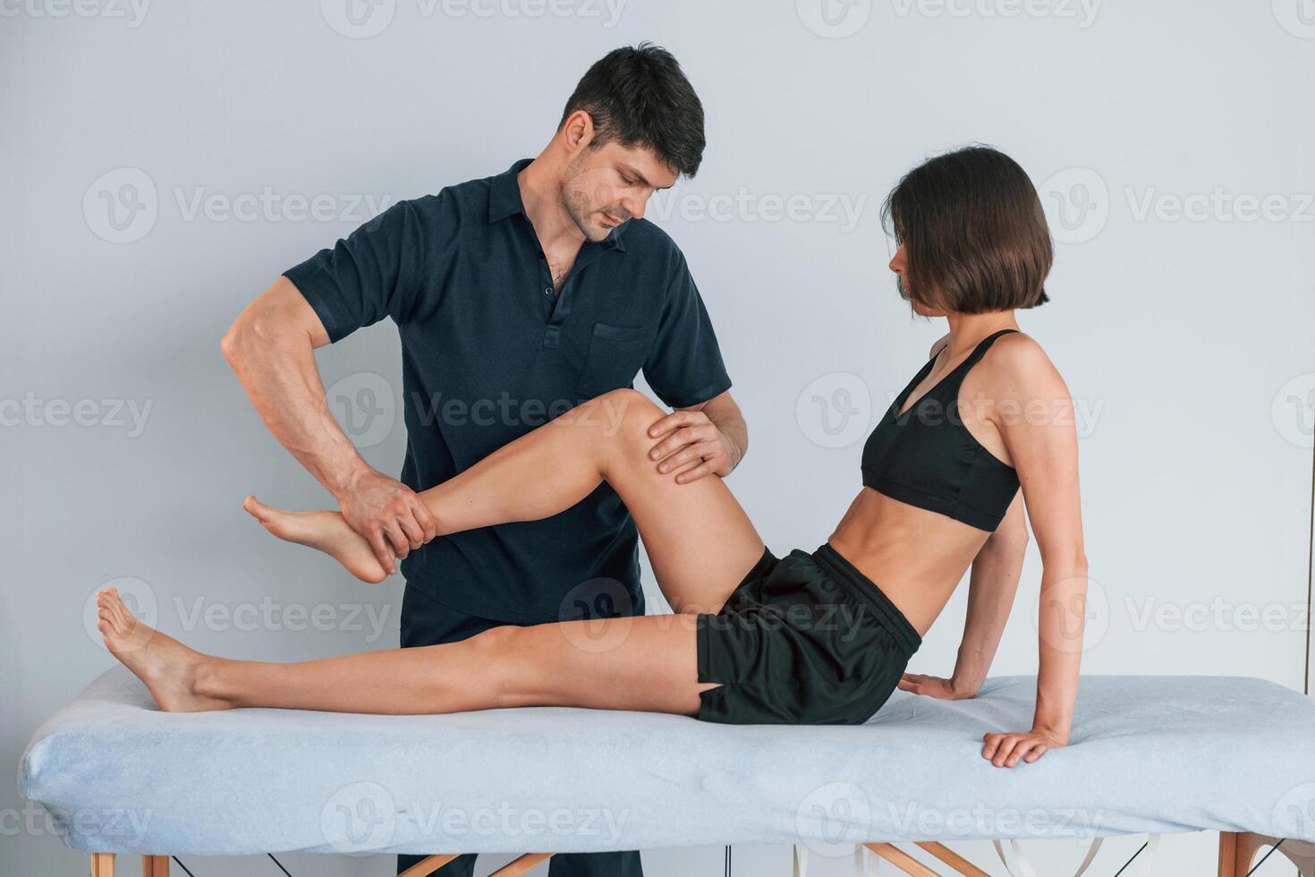 Laying down on the table. Woman visiting physiologist that making massages and helping with a traumas photo