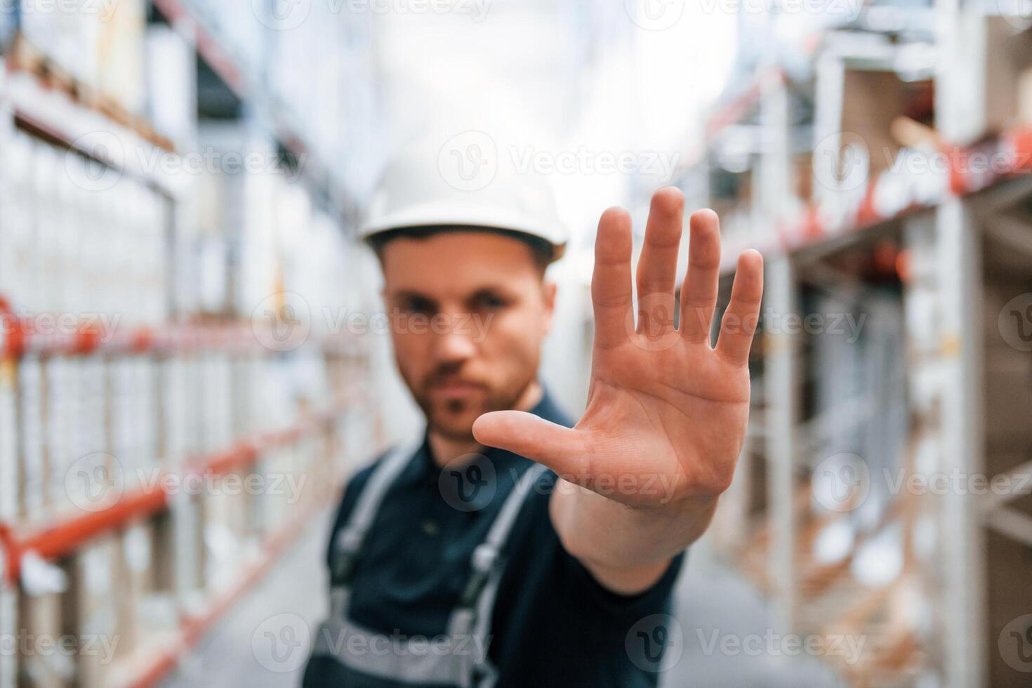 Stop here. No pass. Employee in uniform is working in the storage at daytime photo