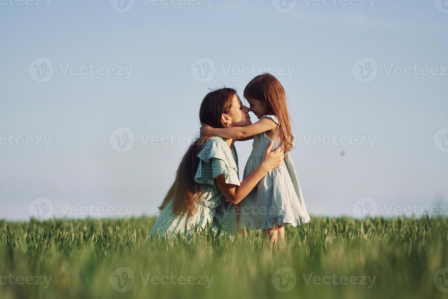 Moment of tenderness. Mother and daughter have fun outdoors on the field at summer..,, photo