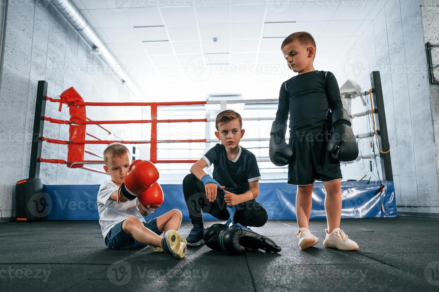 Taking a break,. resting. Boys training boxing in the gym together photo