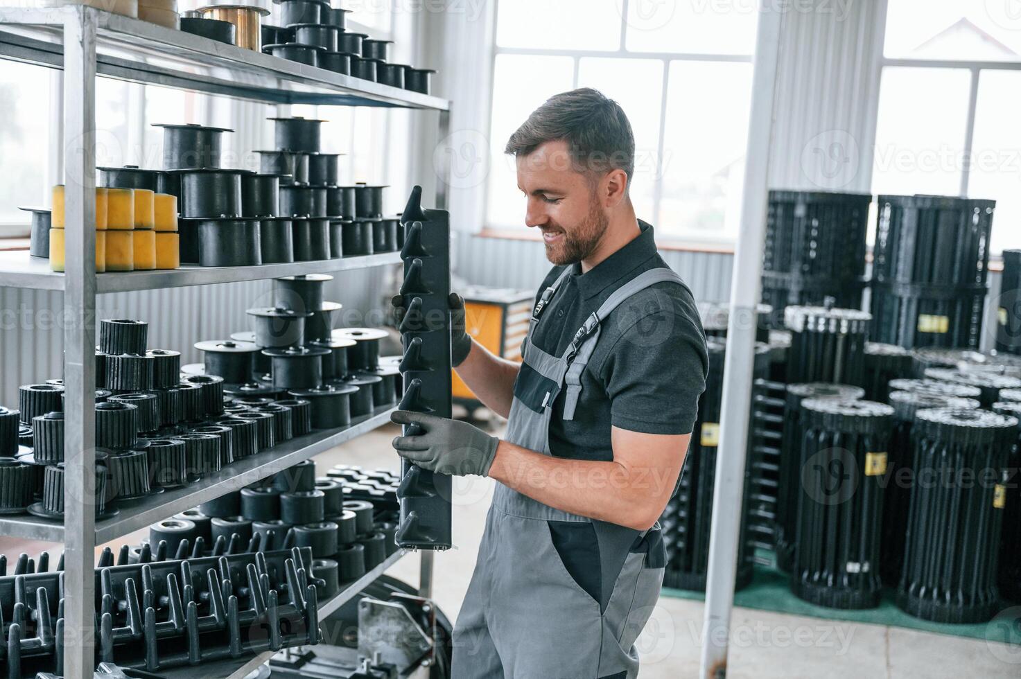 Man in uniform ,is in workstation developing details of agriculture technique photo