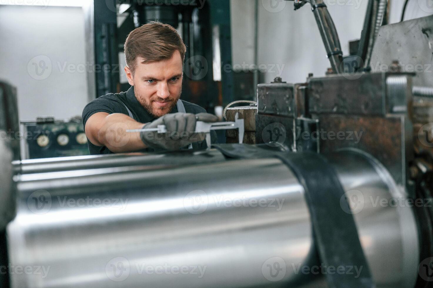 Using measure tool.. Man in uniform is in workstation developing details of agriculture technique photo