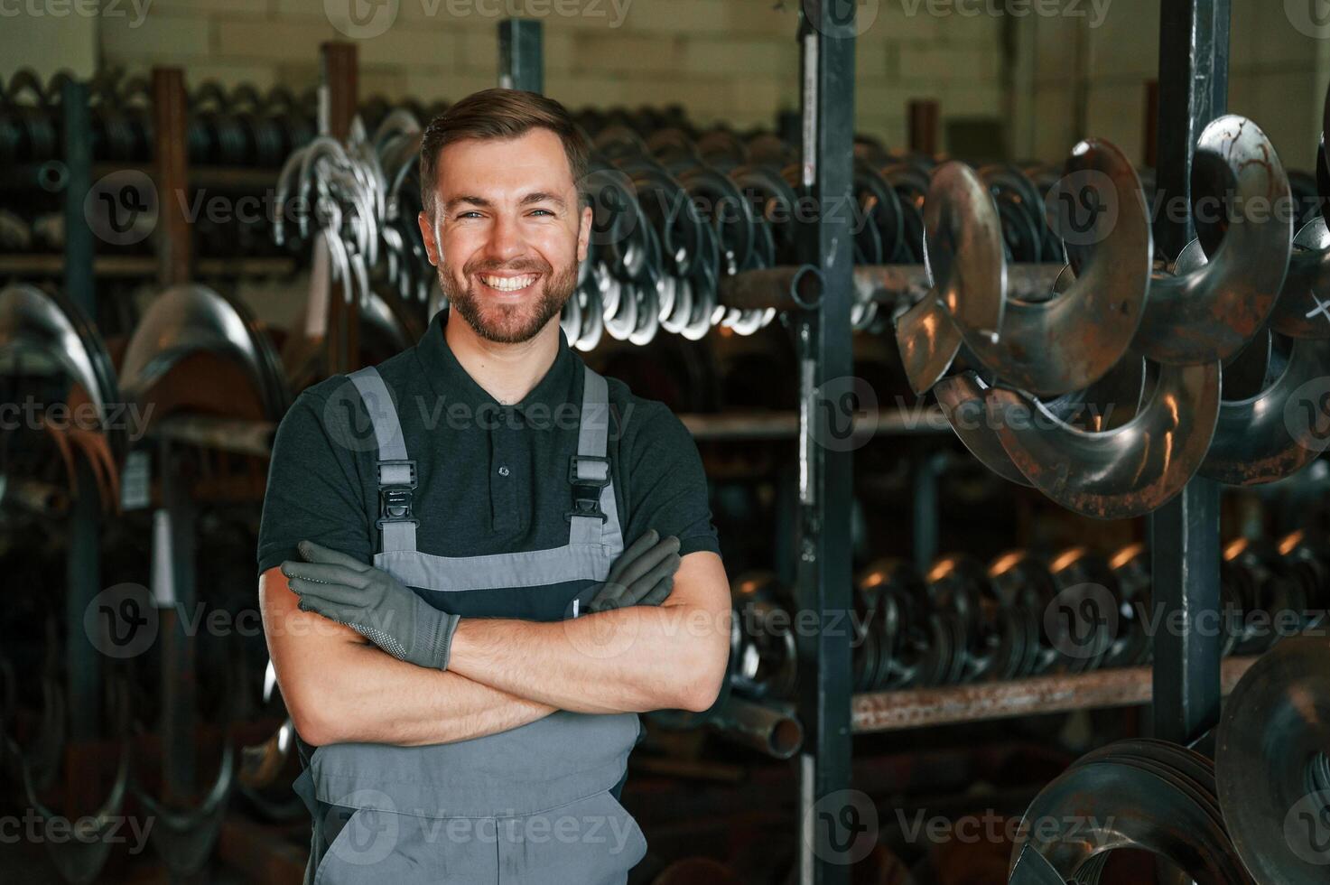 Portrait of man in uniform that is in workstation developing details of agriculture technique.. photo