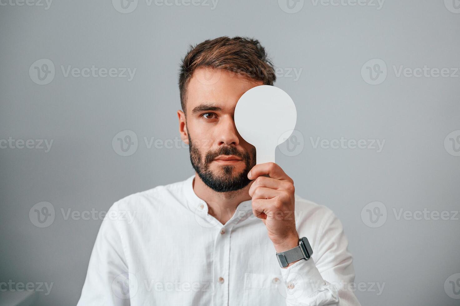 Test of sight.. Man is checking his vision indoors in the clinic photo