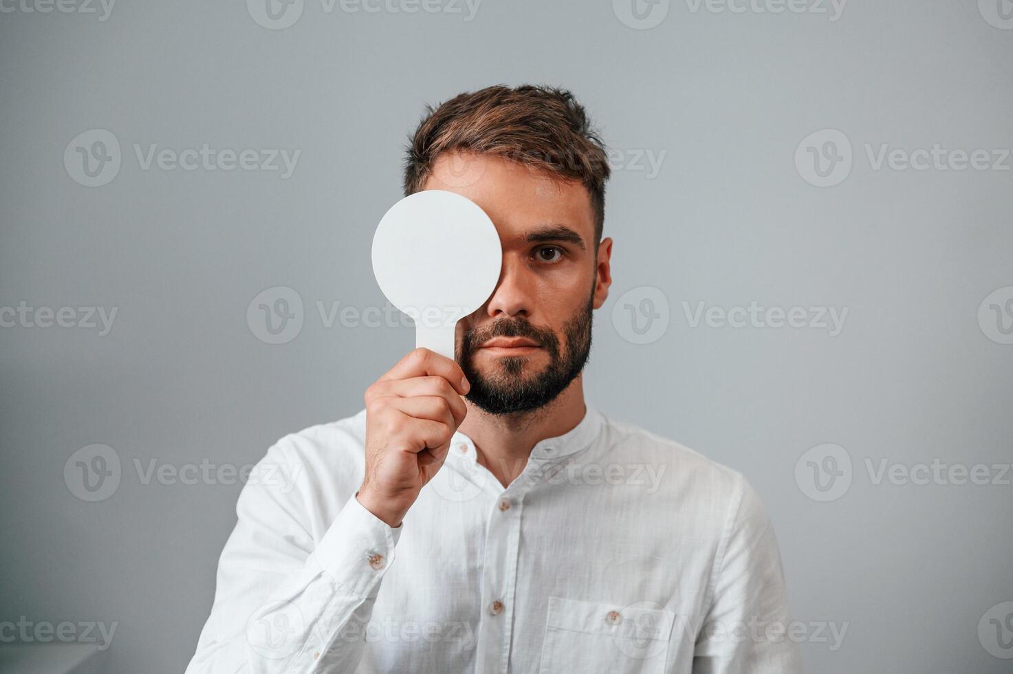 Test of sight. Man is checking ,his vision indoors in the clinic photo