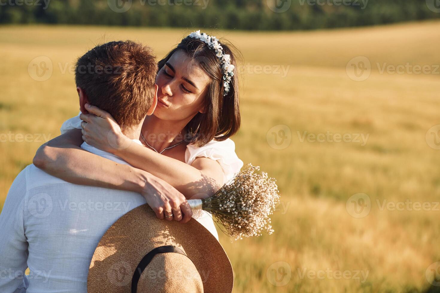 Enjoying the walk. Couple just married. Together on the majestic agricultural field at sunny day., photo