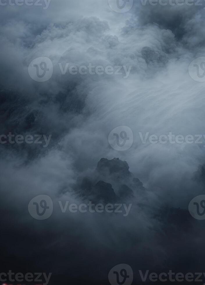 a dark and stormy sky with clouds and fog. Misty Mountain Peak photo