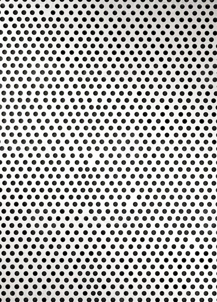 Abstract black and white polka dot pattern on a white background. Perforated Metal Texture photo