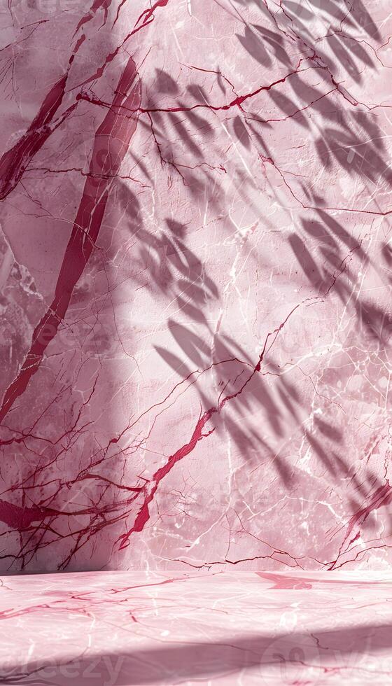 A close-up of pink marble with shadows cast by leaves, creating a serene aesthetic. photo