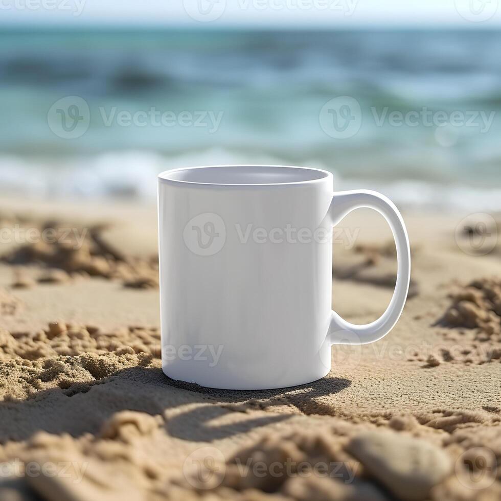 A blank white mug resting on sandy beach, with ocean waves in the background. photo