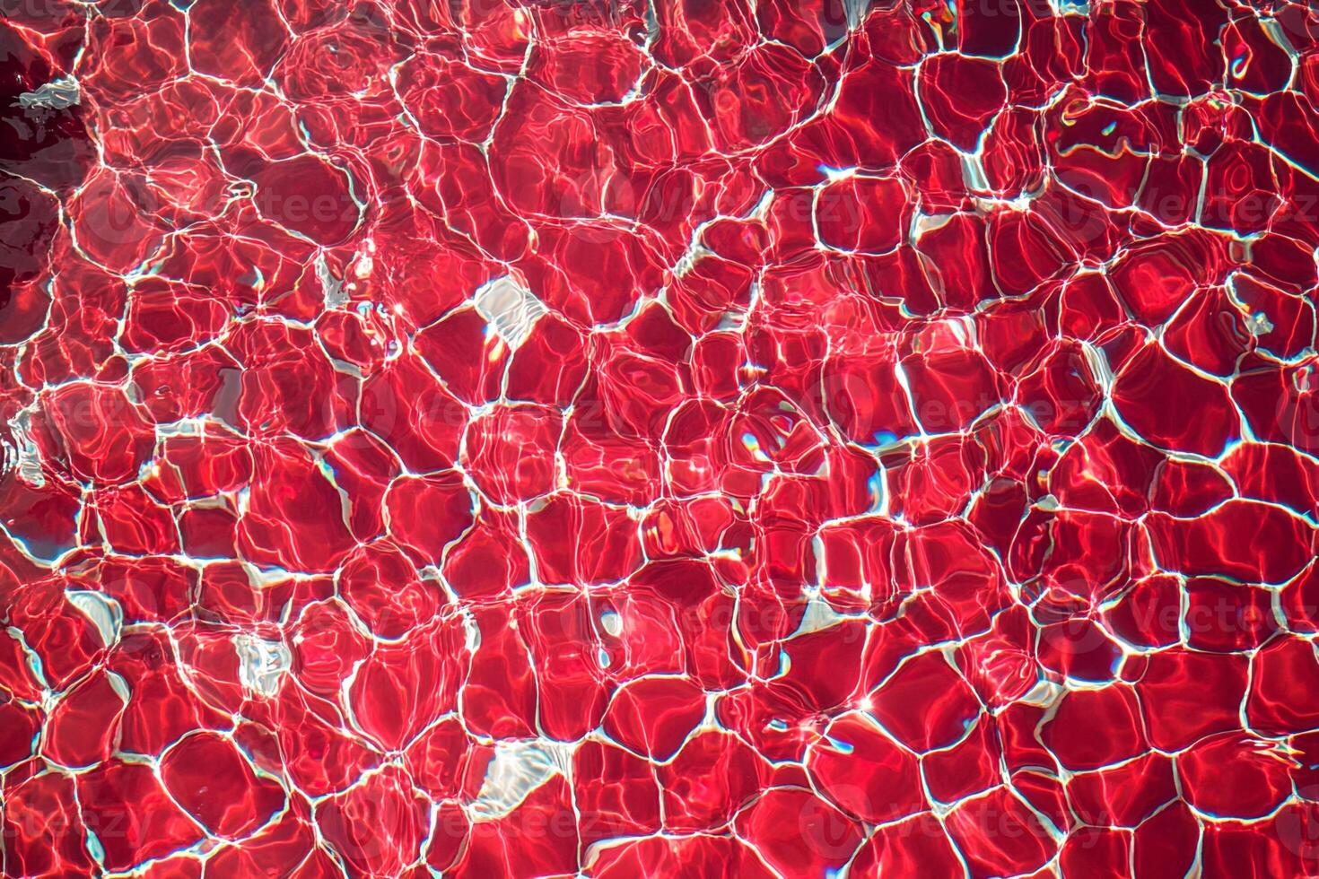 Red Tiled Pool Water Surface with Light Refraction photo