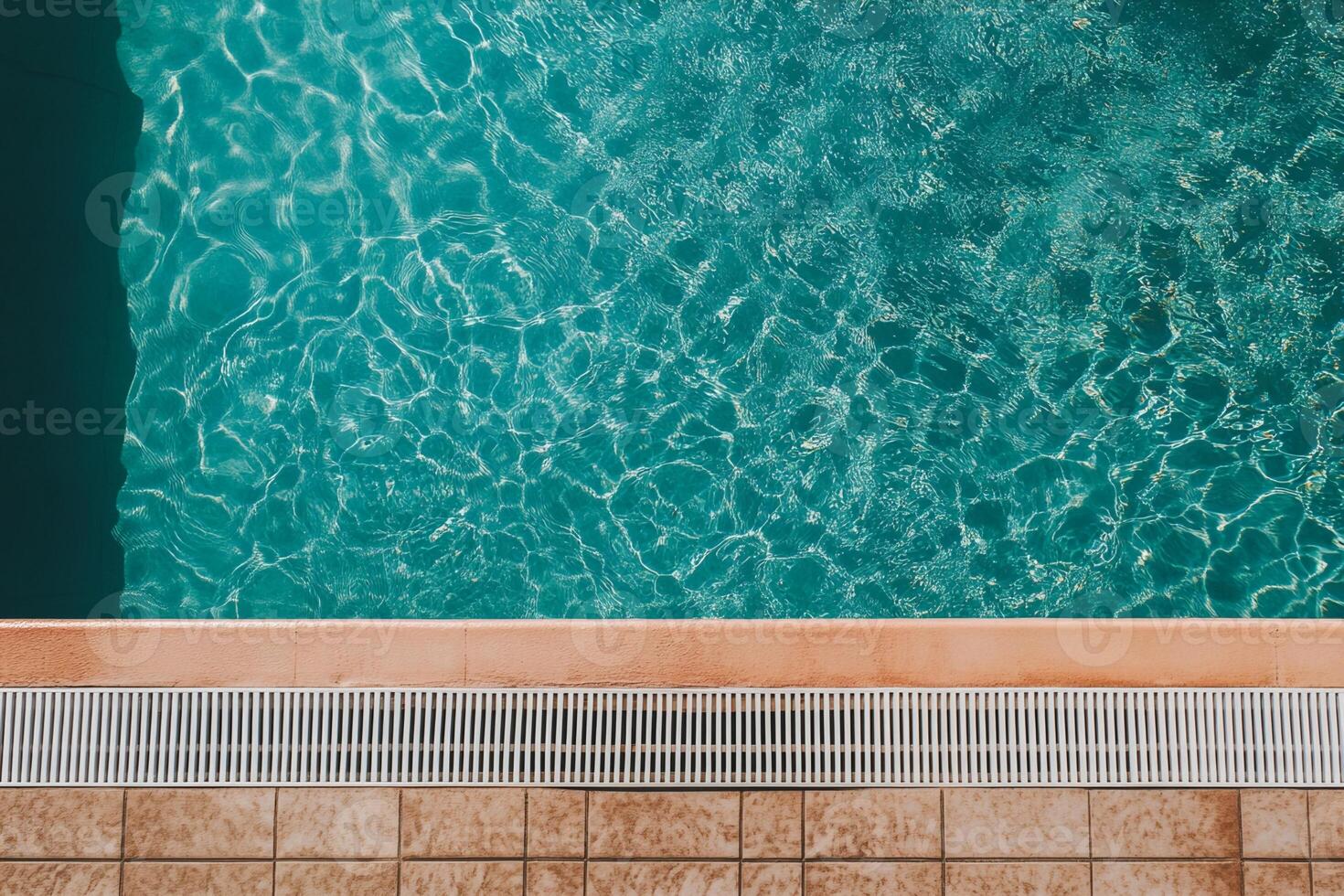 Swimming Pool Edge Teal Water, Drainage Grate, and Tile Deck photo
