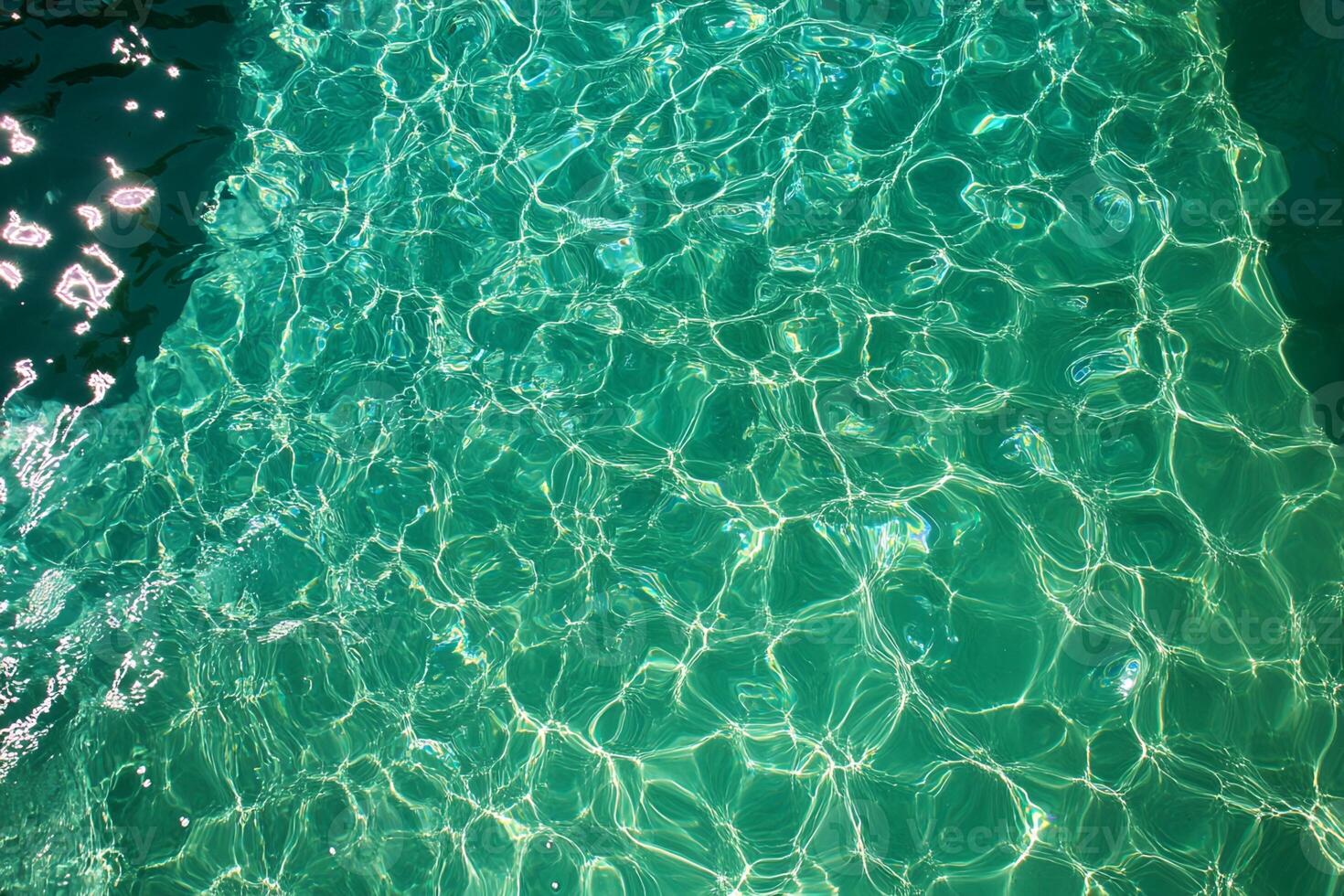 Turquoise Water Surface with Light Reflections photo
