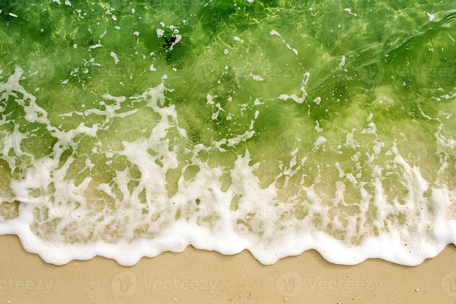Beach Sand, Wave Foam, and Green Seawater photo