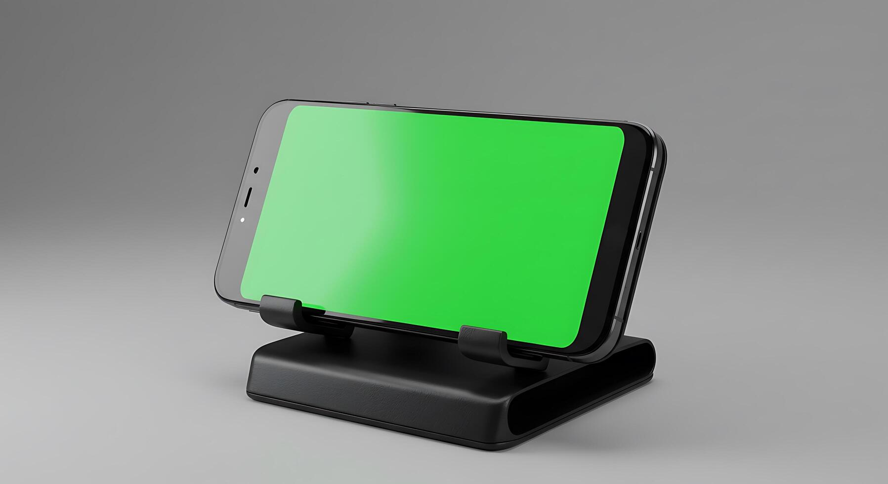 A smartphone with green screen on top of a stand photo