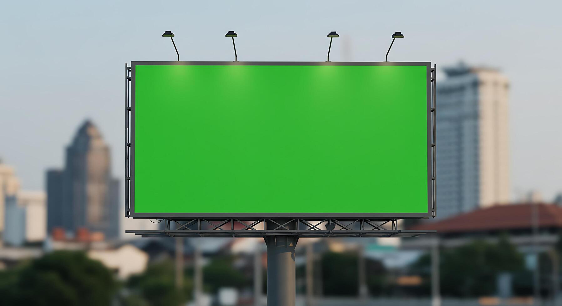 A green billboard on a street with city in the background photo