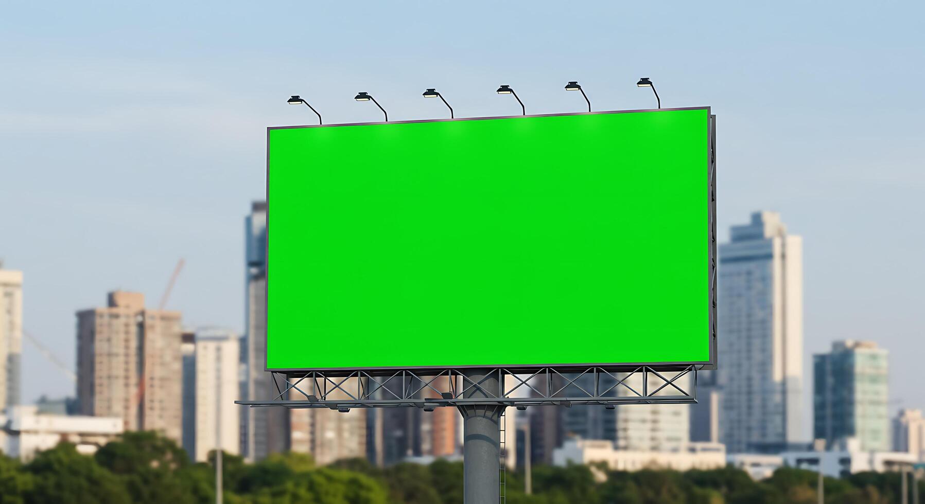 Blank billboard with green screen in front of city skyline photo