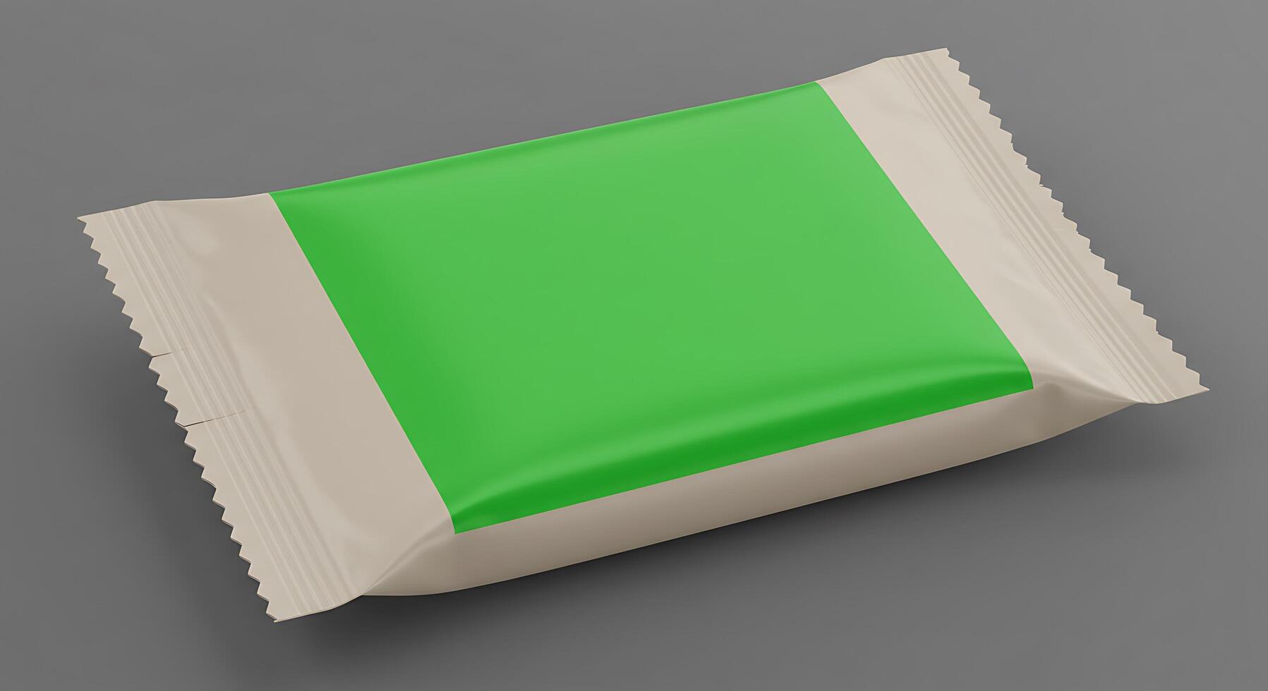 A green and white packet of candy on a gray surface photo