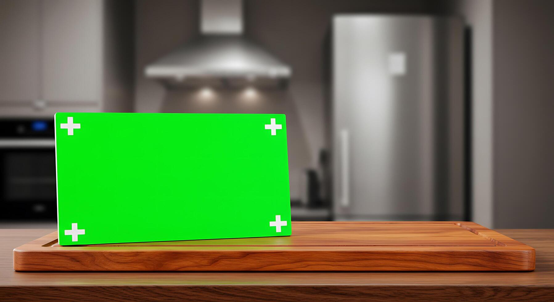 A green board on a wooden cutting board in front of a kitchen photo