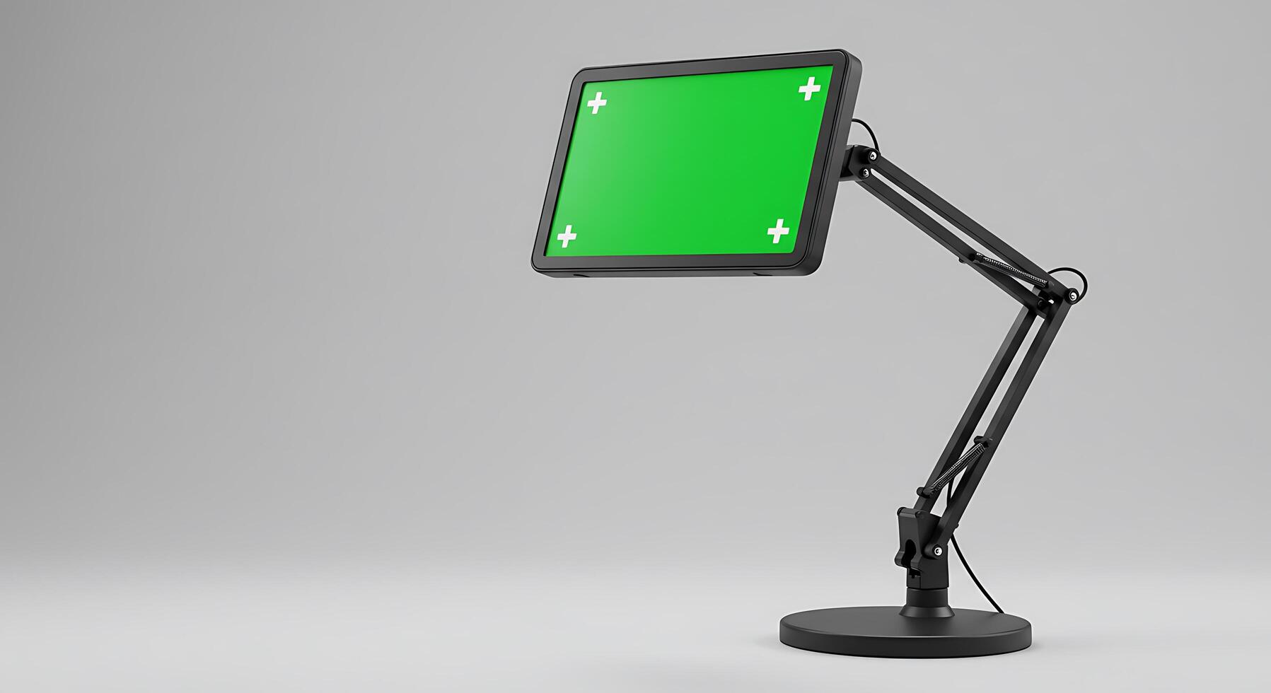 A green screen on a desk with a lamp photo