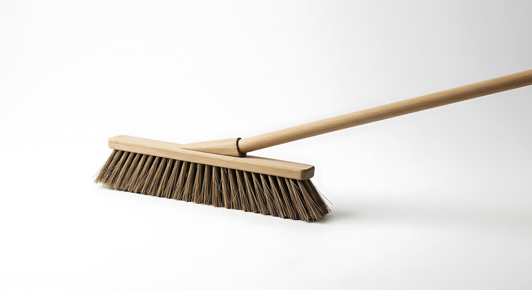 A broom with a wooden handle and a wooden handle photo