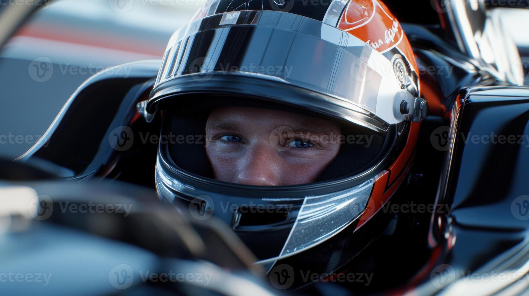 A man in a racing car is looking at the camera photo